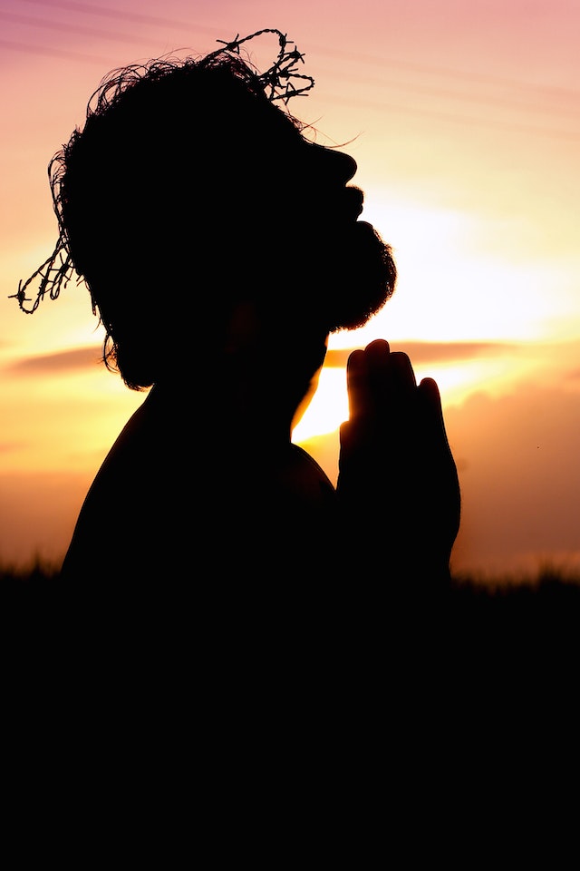 pexels-rodolfo-clix-1615776 Praying hands over Bible